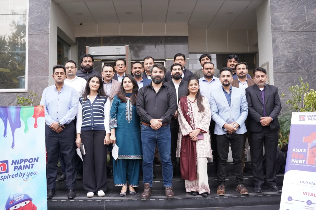 Nippon Paint Pakistan employees posing together outside during their SMART training session.