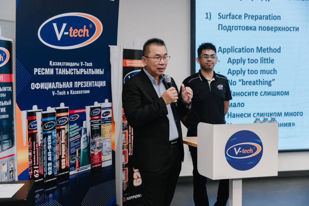 V-tech Co-founder Mr. Cheong Chee Leong speaking with a microphone at the official Kazakhstan brand launch.