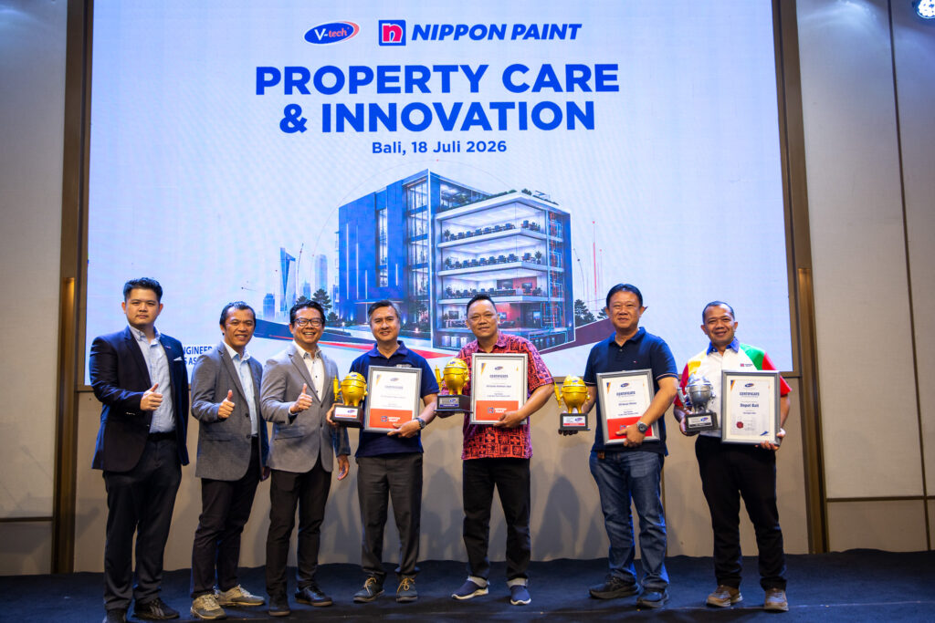 Executives holding trophies on stage during the Property Care & Innovation 2026 forum in Bali.