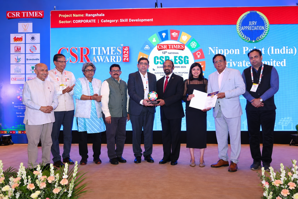 Company representatives on stage receiving the prestigious CSR TIMES Award for youth skill development.