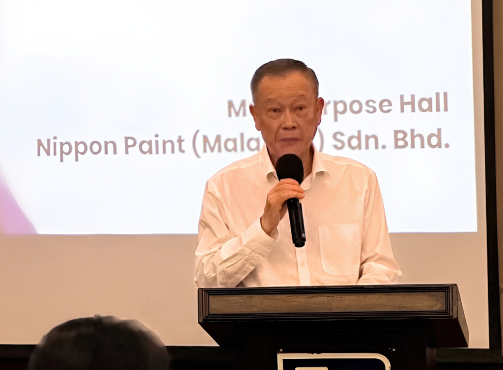 Group Managing Director Yaw Seng Heng speaking at a podium during the Malaysian Town Hall.